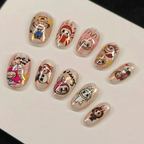 Set of cartoon-themed nail art designs on a white surface