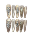 Set of decorative nails with gemstones on a white background