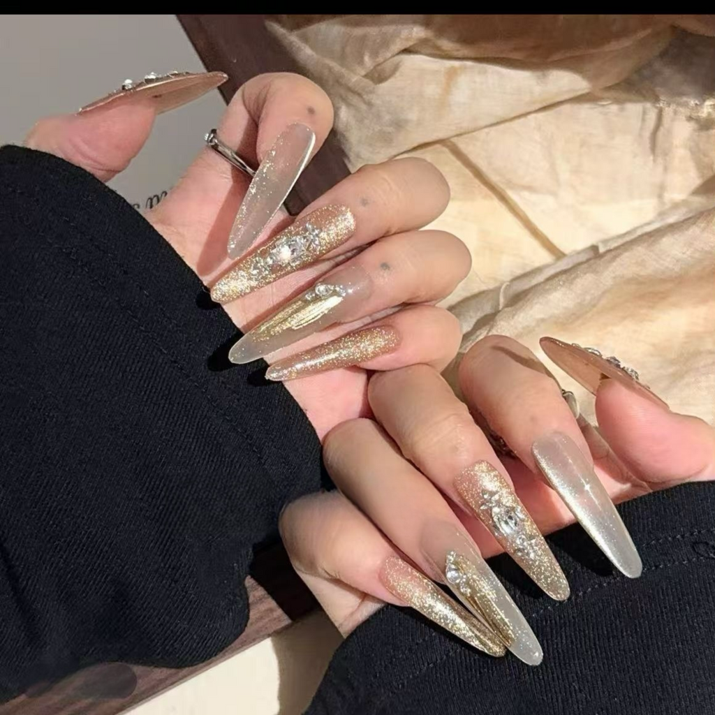 Close-up of hands with long, glittery nails on a neutral background