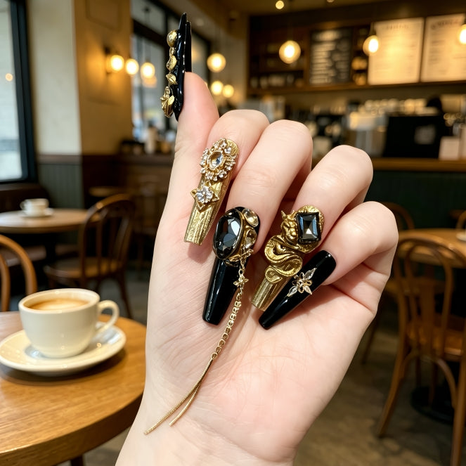 Hand holding three decorative rings with a cafe background