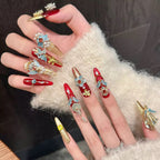 Hand with ornate nail art on a textured surface