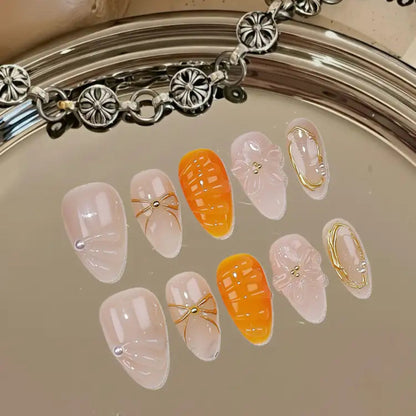 Decorative false nails with gold accents on a reflective surface