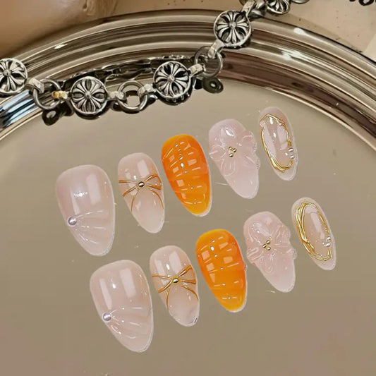 Decorative false nails with gold accents on a reflective surface