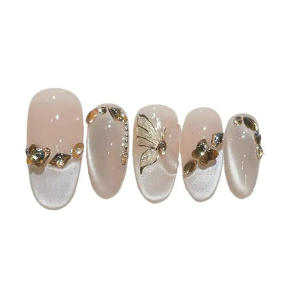 Set of five decorative nails with gold and silver designs on a white background
