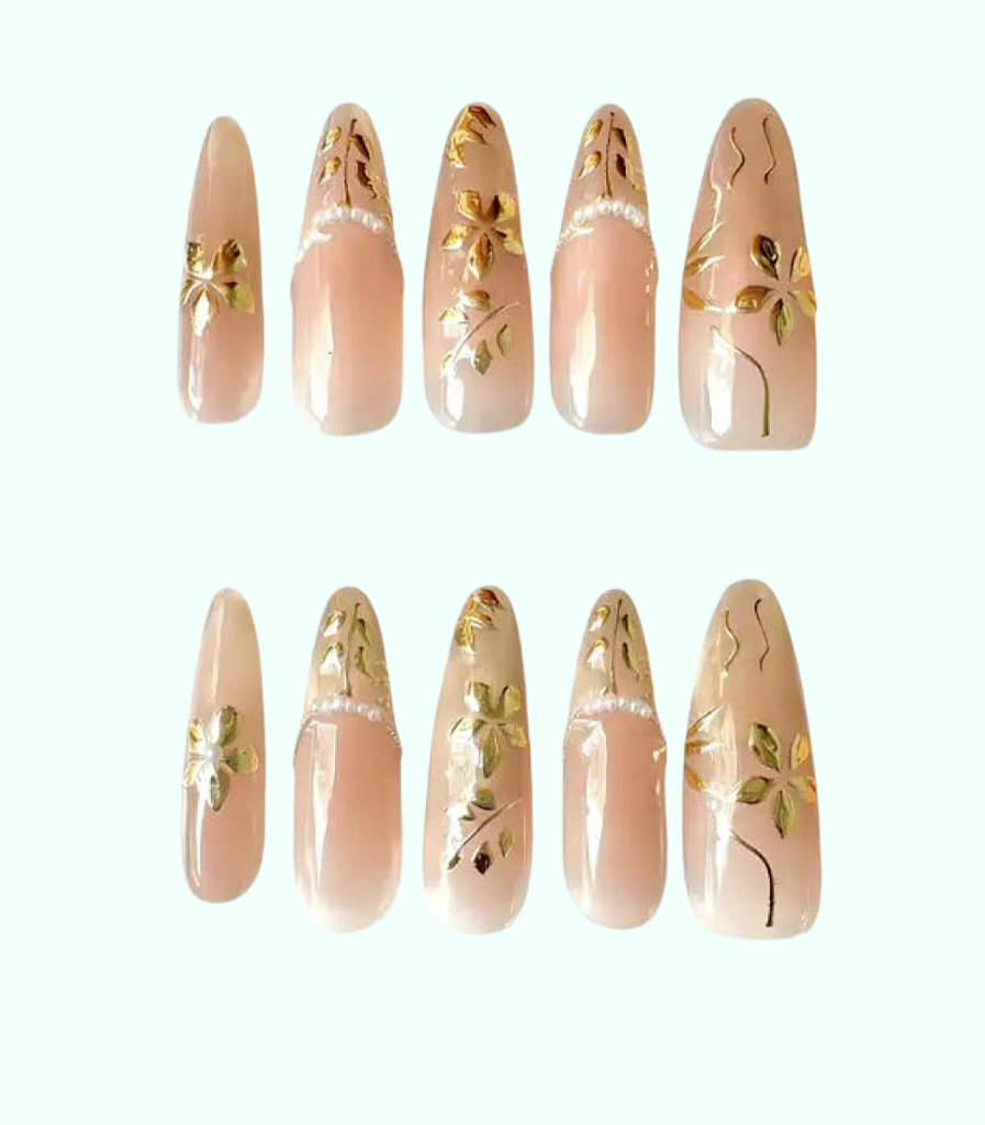 Set of beige nail art designs with gold accents on a white background