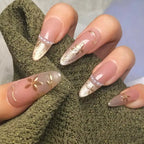 Nails with gold accents on a textured green fabric background