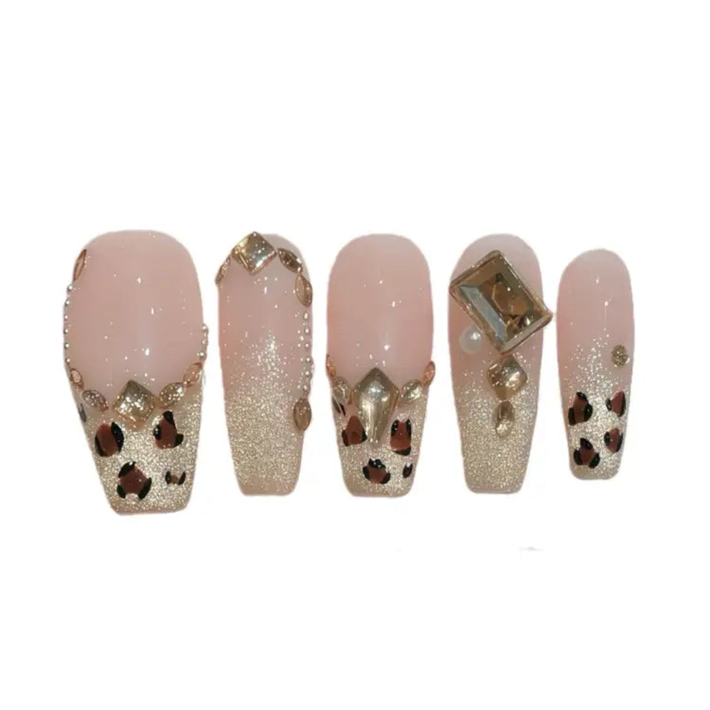 Set of decorative false nails with gold and brown accents on a white background
