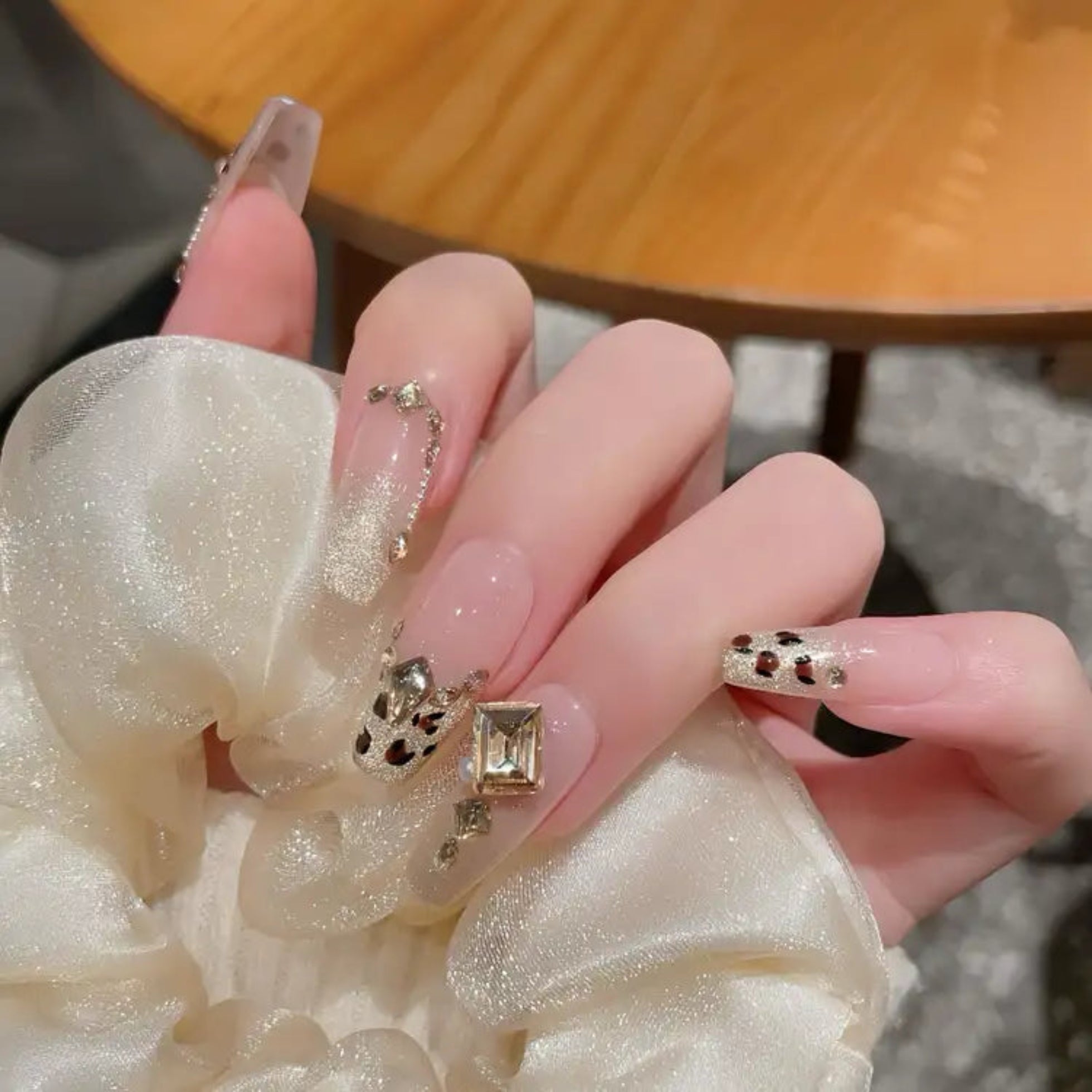 Close-up of a hand wearing multiple rings with a blurred background