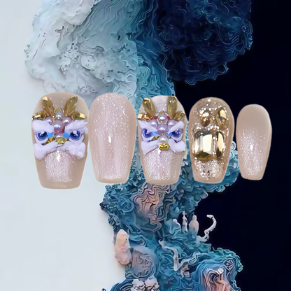 Decorative nails with gold and white designs on a textured blue and white background