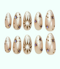 Set of beige nail art designs with decorative elements on a white background