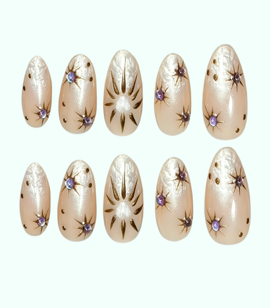 Set of beige nail art designs with decorative elements on a white background