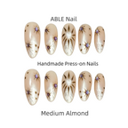 Set of ABLE Nail handmade press-on nails in medium almond design on a white background.