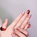 Hand with stylish nail art on a plain background