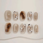 Set of nail designs with brown and beige tones on a light background