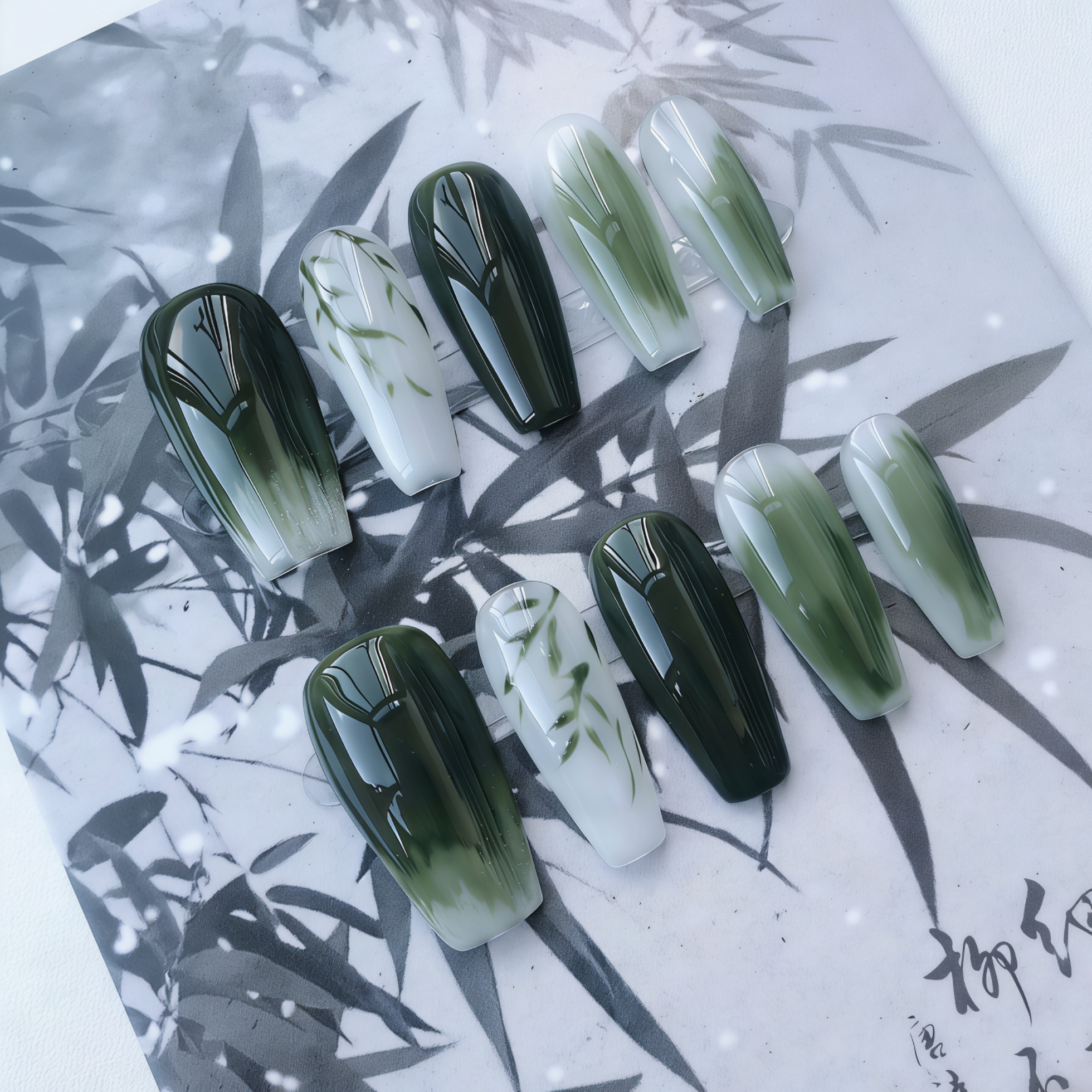 Set of green and black gradient nail art on a leaf-patterned background