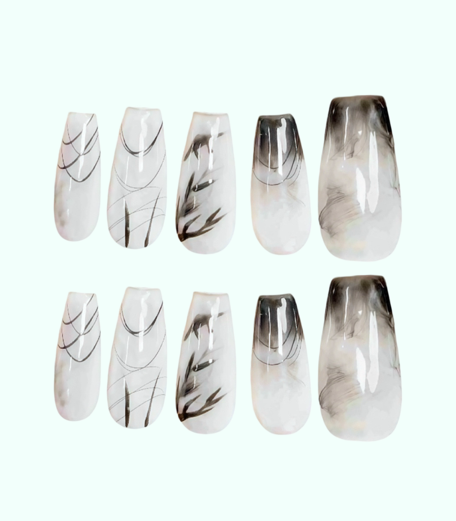Set of press-on nails with black and white marbled design on a white background