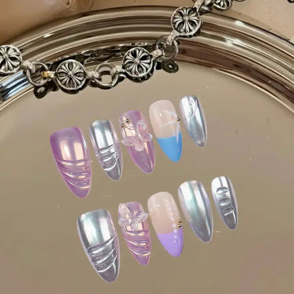 Set of decorative nails with pastel and metallic colors on a reflective surface.