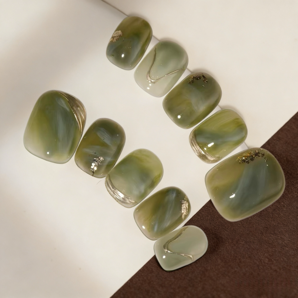 Set of green nail art designs on a white background