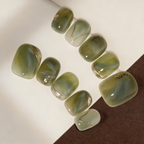 Set of green nail art designs on a white background