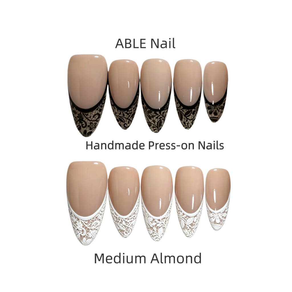 Handmade press-on nails with lace design in medium almond color by ABLE Nail on a white background.