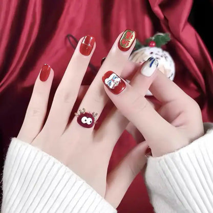 Close-up of hands with red nail polish and decorative designs against a red background