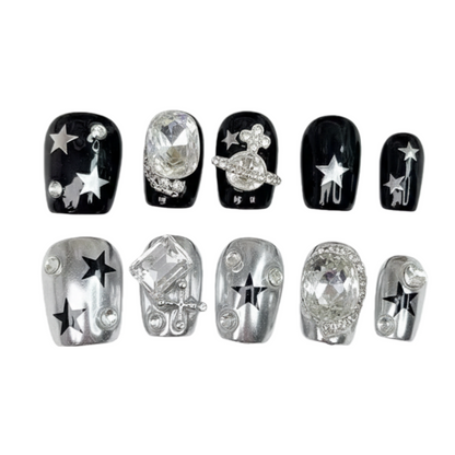 Decorative nail art stickers with stars and crystals on a white background