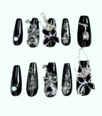 Black and white butterfly nail art designs on a white background