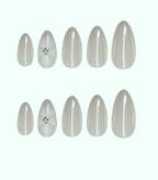 Set of white nail extensions on a white background