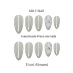 Collection of short almond-shaped press-on nails by ABLE Nail on a white background.