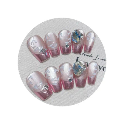 Set of pink and white nail art designs on a circular white mat.
