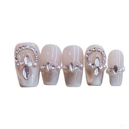 Set of decorative false nails with rhinestones on a white background
