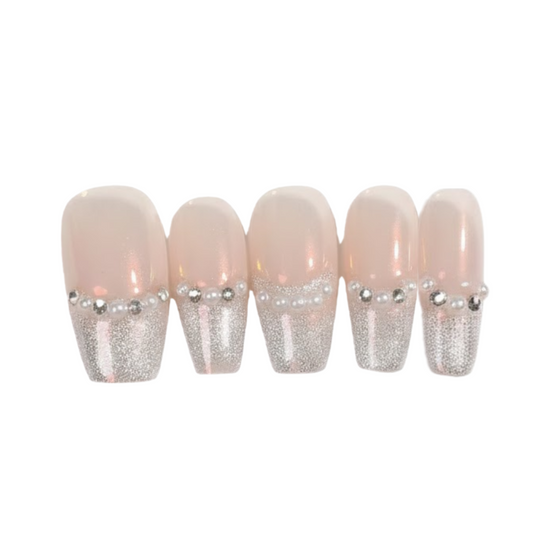 Set of false nails with glittery tips on a white background