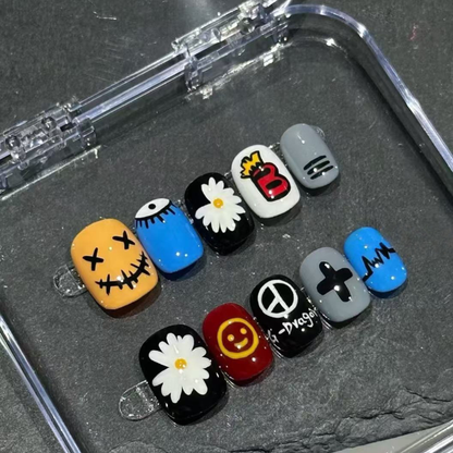 Set of colorful nail art designs in a clear case on a dark surface