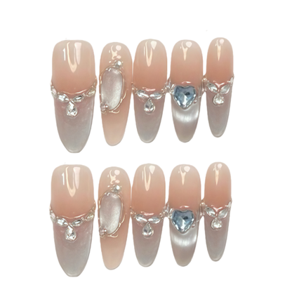 Set of decorative false nails with gemstones on a white background