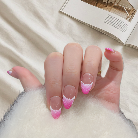 Hand with pink and white gradient nail design on a light background