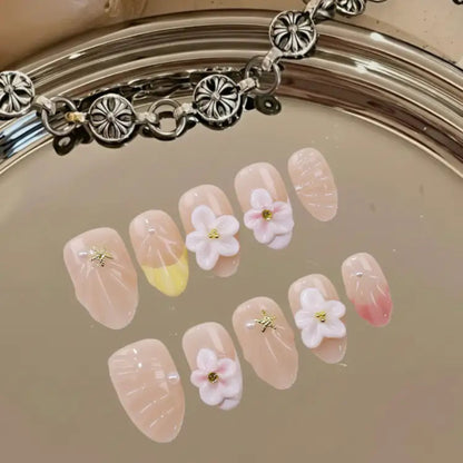 Decorative nail art with flowers and a bracelet on a reflective surface