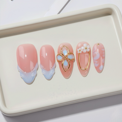 Set of pink and gold nail art designs on a white tray