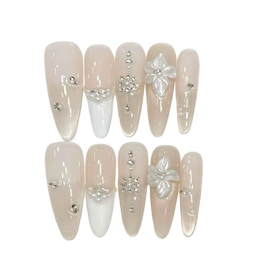 Set of decorative nails with flowers and rhinestones on a white background