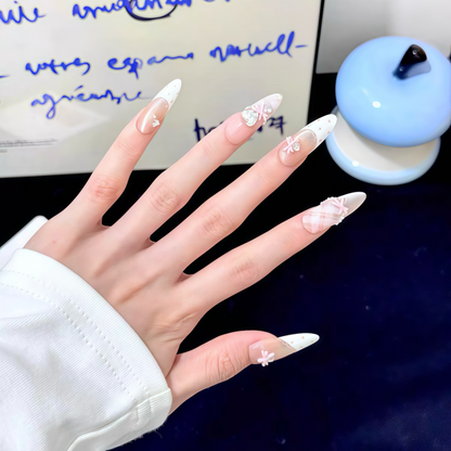 Hand with decorative nails in front of a blurred background