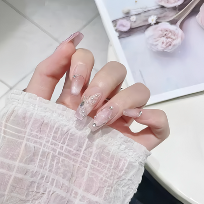 Hand with decorative nail art holding a white plate with flowers