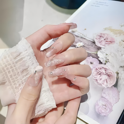 Close-up of a hand with decorative nails holding a floral-themed product packaging.