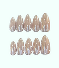 Set of beige nail extensions with white polka dots on a white background