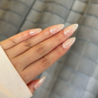 Hand with long, polished nails against a checkered background
