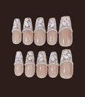 Set of beige nail art designs with floral patterns on a dark background