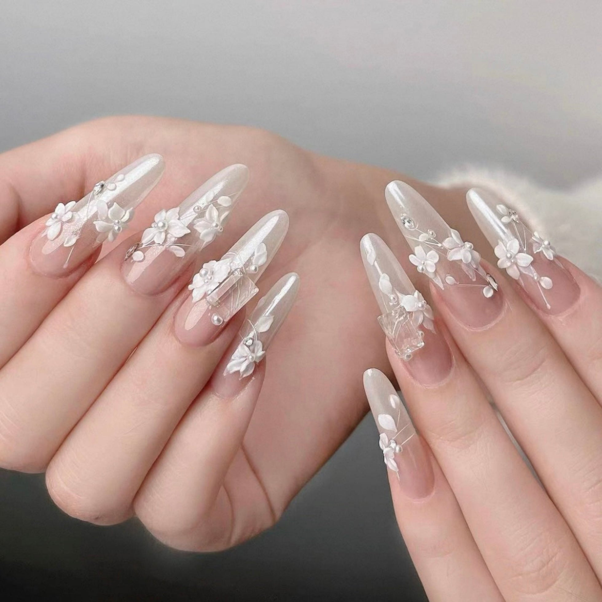 Nails with floral and lace design on a neutral background