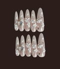 Set of false nails with floral design on a dark background