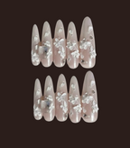 Set of false nails with floral design on a dark background