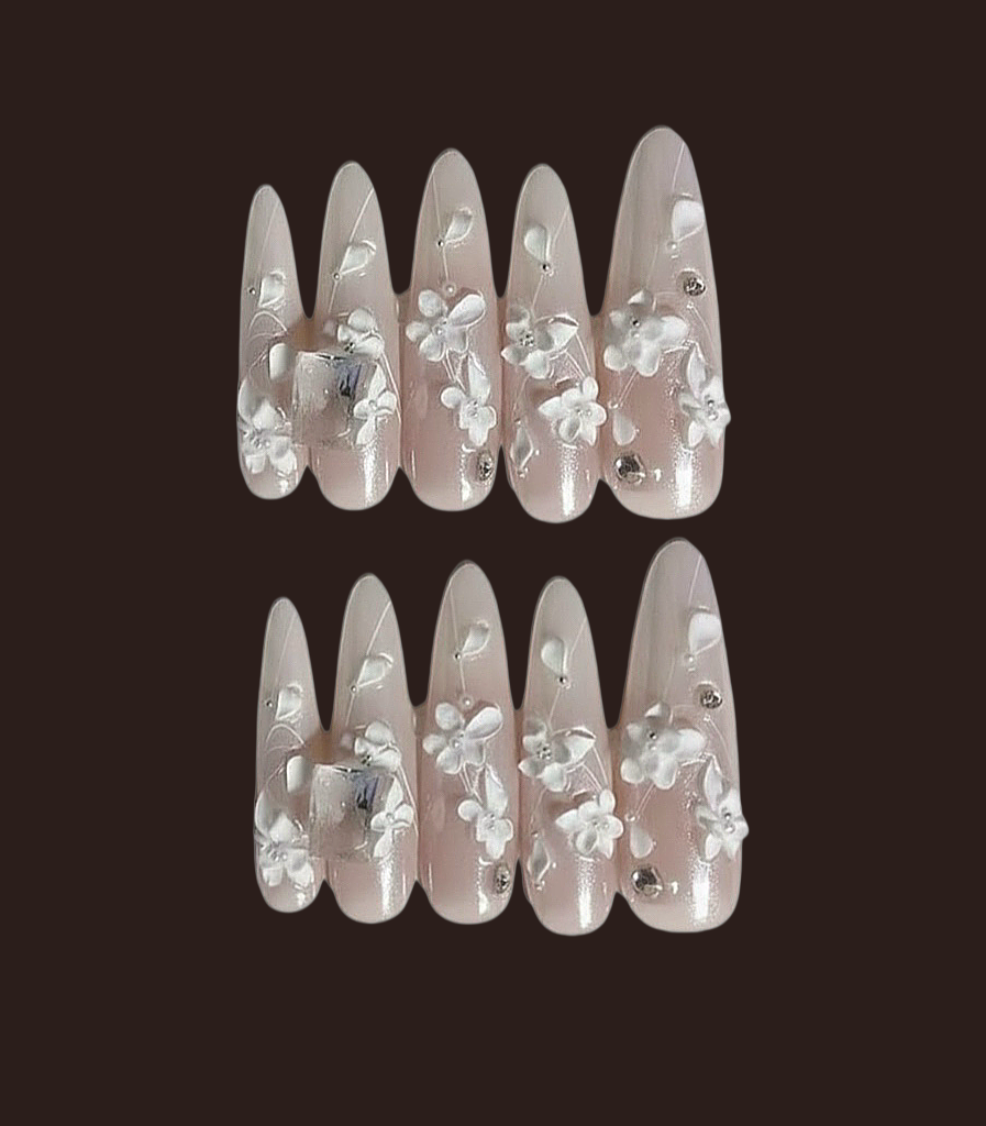 Set of false nails with floral design on a dark background