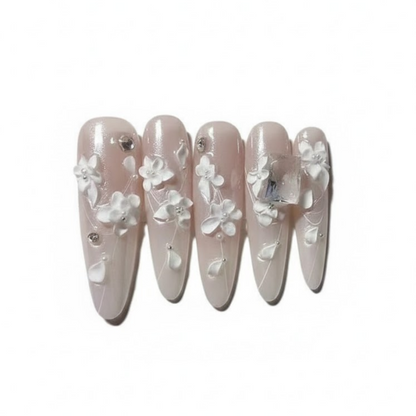 Set of false nails with floral design on a white background
