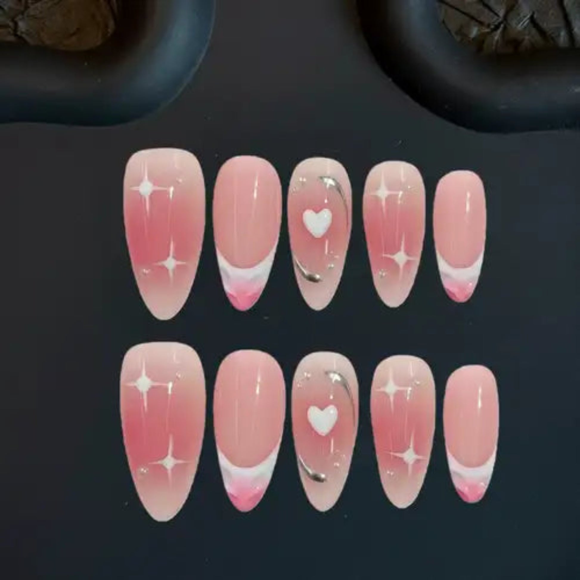 Set of pink nail art designs on a dark background